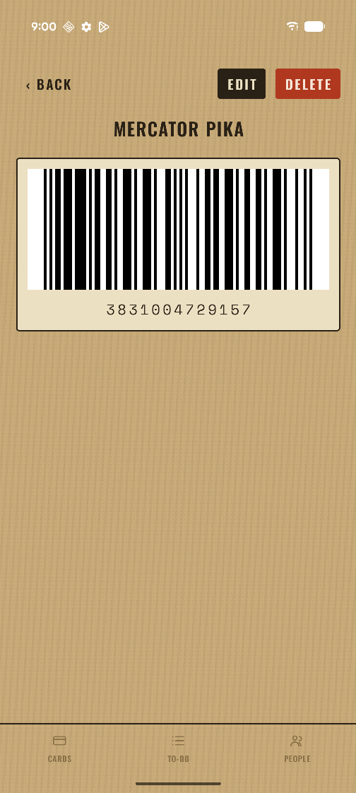 A loyalty card open in Tolar, its barcode filling the width of the screen above the number.